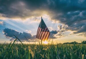 farmland 1031 exchange represented by a farm field with American flag