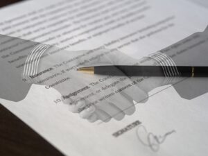 a contract representing a 1031 exchange with an image of a handshake and pen